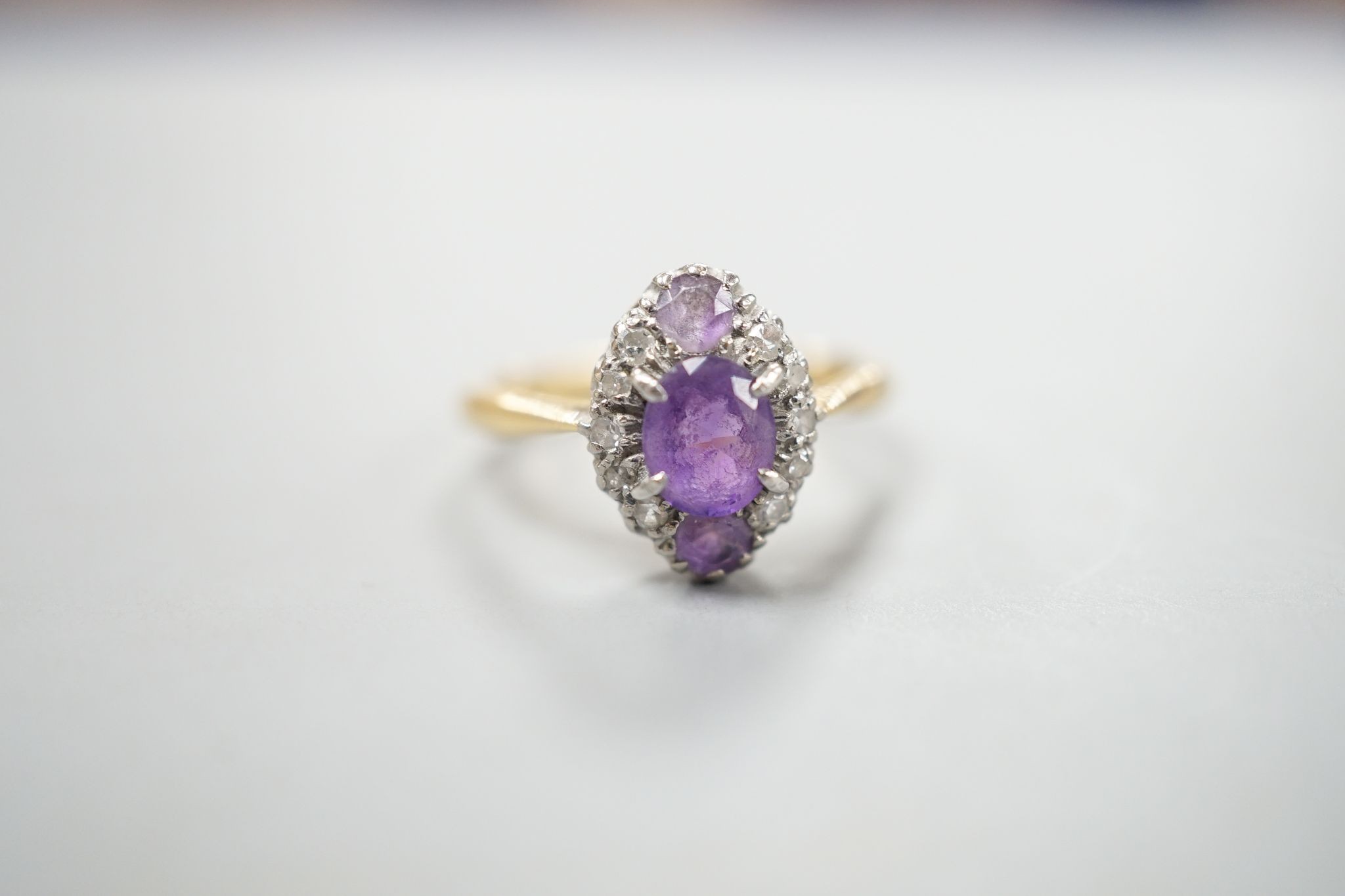 An early 20th century 18ct & plat, amethyst and diamond set marquise cluster ring, size K, gross weight 3.2 grams.